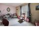 Stylish bedroom with a cozy rocking chair and a well-lit desk area at 7101 Brecken Pl, Lithonia, GA 30058