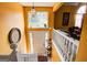 Bright foyer with a large window, elegant pendant light, and decorative mirror in a home with yellow colored walls at 7101 Brecken Pl, Lithonia, GA 30058