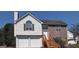 Charming two-story home with vinyl siding, brick accents, attached garage, and wood stairs leading to the entry at 7101 Brecken Pl, Lithonia, GA 30058