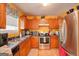 Well-equipped kitchen with stainless steel appliances, wooden cabinets, and ample counter space at 7101 Brecken Pl, Lithonia, GA 30058