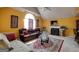 Cozy living room featuring a fireplace, vaulted ceiling, plush seating, and large windows at 7101 Brecken Pl, Lithonia, GA 30058