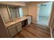 Bathroom with double vanity, granite counters, and wood look floors at 108 Deer Xing, Temple, GA 30179