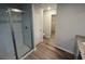 Modern bathroom featuring a glass shower, granite countertop, and wood-look flooring at 108 Deer Xing, Temple, GA 30179