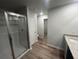 Modern bathroom featuring a glass shower, granite countertop, and wood-look flooring at 108 Deer Xing, Temple, GA 30179