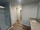 Modern bathroom featuring a glass shower, granite countertop, and wood-look flooring at 108 Deer Xing, Temple, GA 30179