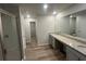 Bathroom with double vanity sinks, modern shower, and wood floors at 108 Deer Xing, Temple, GA 30179