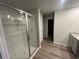 Bathroom featuring a tiled shower and wood-look flooring at 108 Deer Xing, Temple, GA 30179