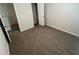 A gray carpeted bedroom featuring a closet with a white door at 108 Deer Xing, Temple, GA 30179