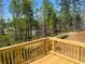 Wooden deck offering scenic views of the wooded lot and neighborhood at 108 Deer Xing, Temple, GA 30179