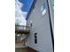 Side view of a two-story home featuring light gray siding and a wooden balcony at 108 Deer Xing, Temple, GA 30179