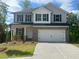 Beautiful two-story home with a brick and siding exterior, a two-car garage, and a well-manicured lawn at 108 Deer Xing, Temple, GA 30179