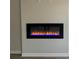 Modern electric fireplace with vibrant blue and orange flames, set against a sleek wall at 108 Deer Xing, Temple, GA 30179