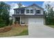 Charming two-story house with a two-car garage, new lawn, and manicured landscaping at 108 Deer Xing, Temple, GA 30179