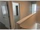 Upstairs hallway with doorways leading to bedrooms and bathrooms, featuring neutral paint at 108 Deer Xing, Temple, GA 30179