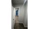 Hallway leading to a bedroom with hard surface flooring and carpet at 108 Deer Xing, Temple, GA 30179