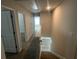 Hallway on upper level featuring carpet, leading to a landing overlooking the hardwood floors below at 108 Deer Xing, Temple, GA 30179