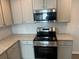 Modern kitchen with stainless steel appliances, granite countertops, and white cabinets at 108 Deer Xing, Temple, GA 30179