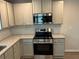 Well-equipped kitchen with stainless steel appliances, granite countertops, and white cabinets at 108 Deer Xing, Temple, GA 30179