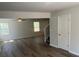 Spacious living room showcasing light gray vinyl floors, neutral walls, and natural light at 108 Deer Xing, Temple, GA 30179