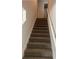 Carpeted staircase with white railing leading to the upper level of the home, providing easy access at 108 Deer Xing, Temple, GA 30179