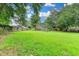 Expansive backyard featuring lush grass, mature trees, and a wooden fence at 2508 Wagon Trce, Duluth, GA 30096