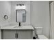 Modern bathroom features a neutral vanity, bright lighting and a framed mirror at 2508 Wagon Trce, Duluth, GA 30096