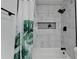 Modern bathroom with marble-look tile, updated fixtures and shower with green accent at 2508 Wagon Trce, Duluth, GA 30096