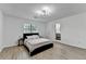 Bright bedroom featuring wood-look floors, large windows, and a view to the bathroom at 2508 Wagon Trce, Duluth, GA 30096