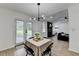Bright dining area with modern light fixture and access to backyard and living room at 2508 Wagon Trce, Duluth, GA 30096