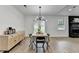 Open concept dining area with modern lighting, view of the backyard, and living space at 2508 Wagon Trce, Duluth, GA 30096