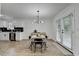Eat-in kitchen featuring stainless steel appliances, modern lighting, and outdoor access at 2508 Wagon Trce, Duluth, GA 30096
