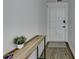 Inviting entryway with a console table and minimalist decor, showcasing wood-look flooring at 2508 Wagon Trce, Duluth, GA 30096