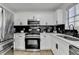 Updated kitchen featuring stainless steel appliances, white cabinets, and marble backsplash at 2508 Wagon Trce, Duluth, GA 30096