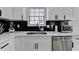A modern kitchen features white cabinets, stainless steel appliances and black marble backsplash at 2508 Wagon Trce, Duluth, GA 30096