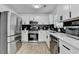Modern kitchen with stainless steel appliances, black marble backsplash, and ample countertop space at 2508 Wagon Trce, Duluth, GA 30096