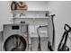 Well-organized laundry area with modern washer and dryer, storage baskets and shelving at 2508 Wagon Trce, Duluth, GA 30096