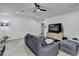 Bright living room features recessed lighting, modern ceiling fan, and stylish gray sofa at 2508 Wagon Trce, Duluth, GA 30096