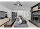 Open-concept living space with a fireplace, stylish furniture, and seamless flow to the dining area at 2508 Wagon Trce, Duluth, GA 30096