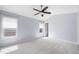 Neutral bedroom with carpet, ceiling fan, and natural light from two windows at 260 Manning Sw Rd # 76, Marietta, GA 30064