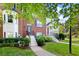 Well-maintained townhome with a brick facade, green lawn, and walkway at 260 Manning Sw Rd # 76, Marietta, GA 30064