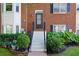 Close up of the front of a townhome with brick facade and landscaped entrance at 260 Manning Sw Rd # 76, Marietta, GA 30064