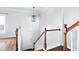 Bright hallway with wood floors, white railings, and decorative light fixture at 260 Manning Sw Rd # 76, Marietta, GA 30064