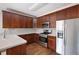 Well-lit kitchen features stainless steel appliances, wooden cabinetry, and plenty of countertop space at 260 Manning Sw Rd # 76, Marietta, GA 30064