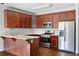 Well-lit kitchen features stainless steel appliances, wooden cabinetry, and a functional center island at 260 Manning Sw Rd # 76, Marietta, GA 30064