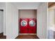 Laundry closet with front-loading red washer and dryer at 260 Manning Sw Rd # 76, Marietta, GA 30064