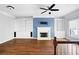 Open living room featuring wood floors, fireplace, and custom built-in shelving at 260 Manning Sw Rd # 76, Marietta, GA 30064