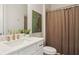 Well-lit bathroom with a white vanity, gold fixtures, and a shower with a neutral-toned curtain at 3332 Old Concord Se Rd, Smyrna, GA 30082