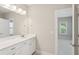 Bathroom with double sink vanity, ample storage, and a large mirror creating an open feel at 3332 Old Concord Se Rd, Smyrna, GA 30082