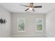 A bedroom featuring a ceiling fan, two windows, and a TV wall mount at 3332 Old Concord Se Rd, Smyrna, GA 30082