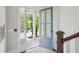 Bright foyer with a glass-paneled blue front door, staircase, and views of the landscaped front yard at 3332 Old Concord Se Rd, Smyrna, GA 30082